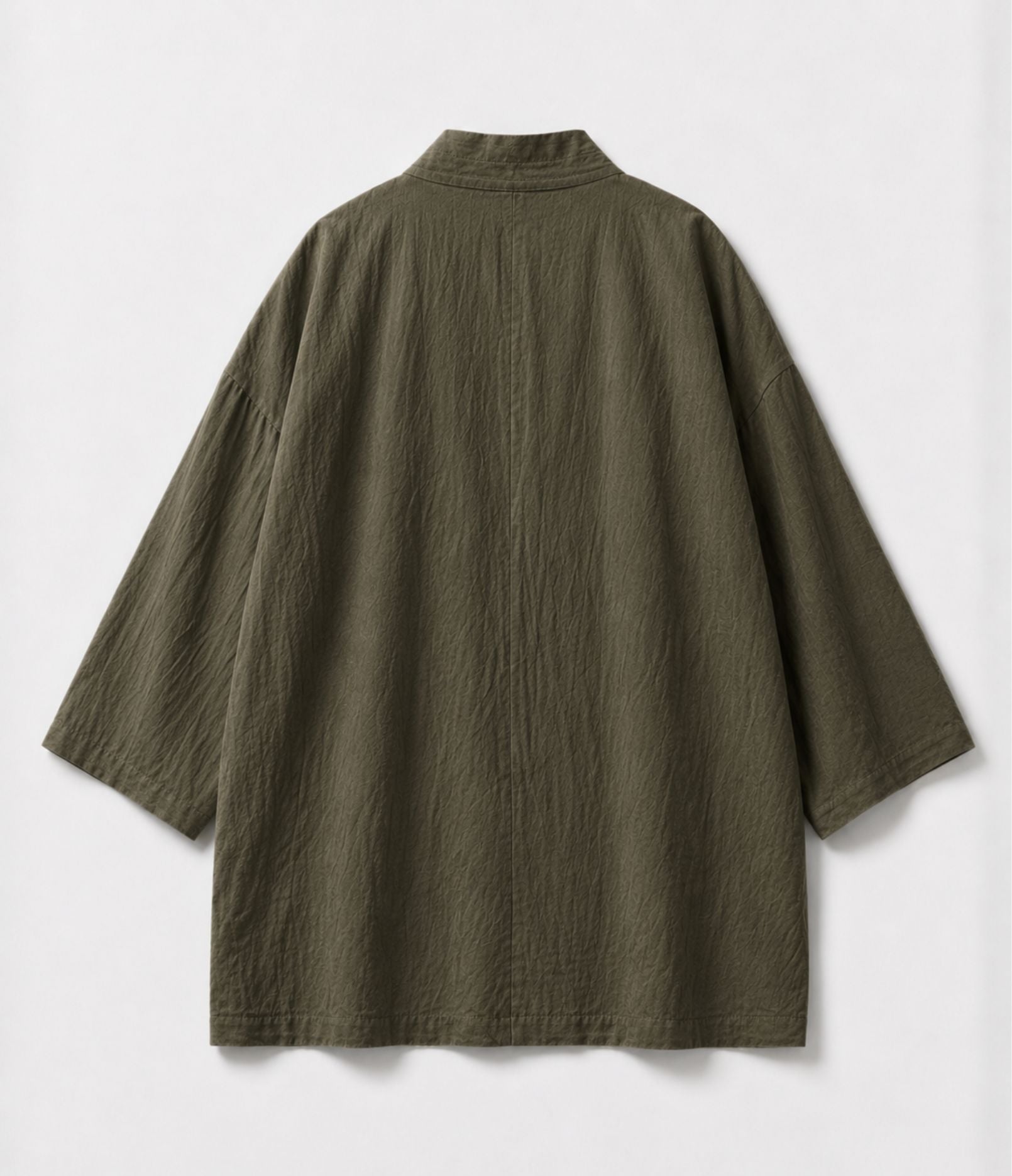 Back of a khaki kimono jacket showing centre seam and wide sleeves