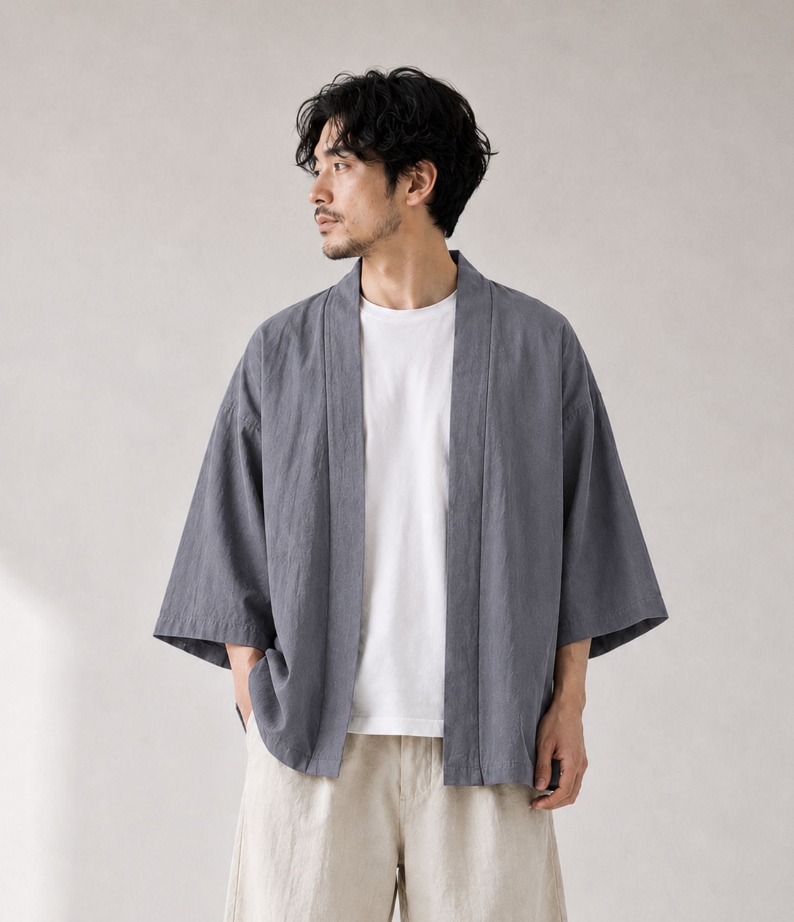 Man wearing a grey noragi kimono cardigan over a white tee