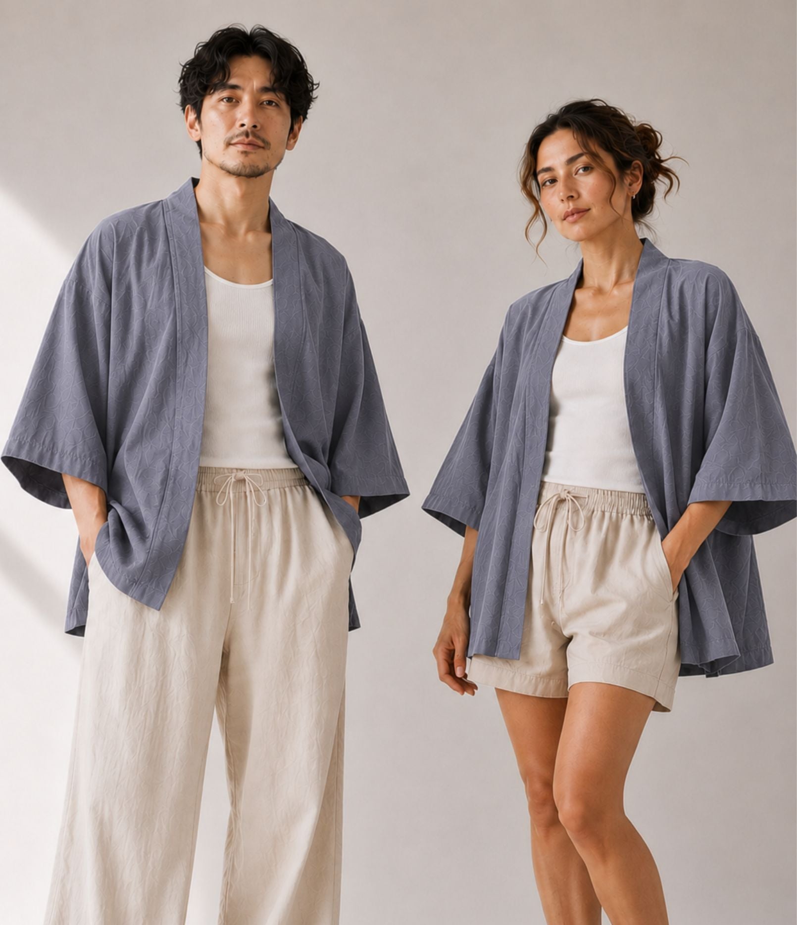 Man and woman wearing matching grey unisex haori jackets over white tanks