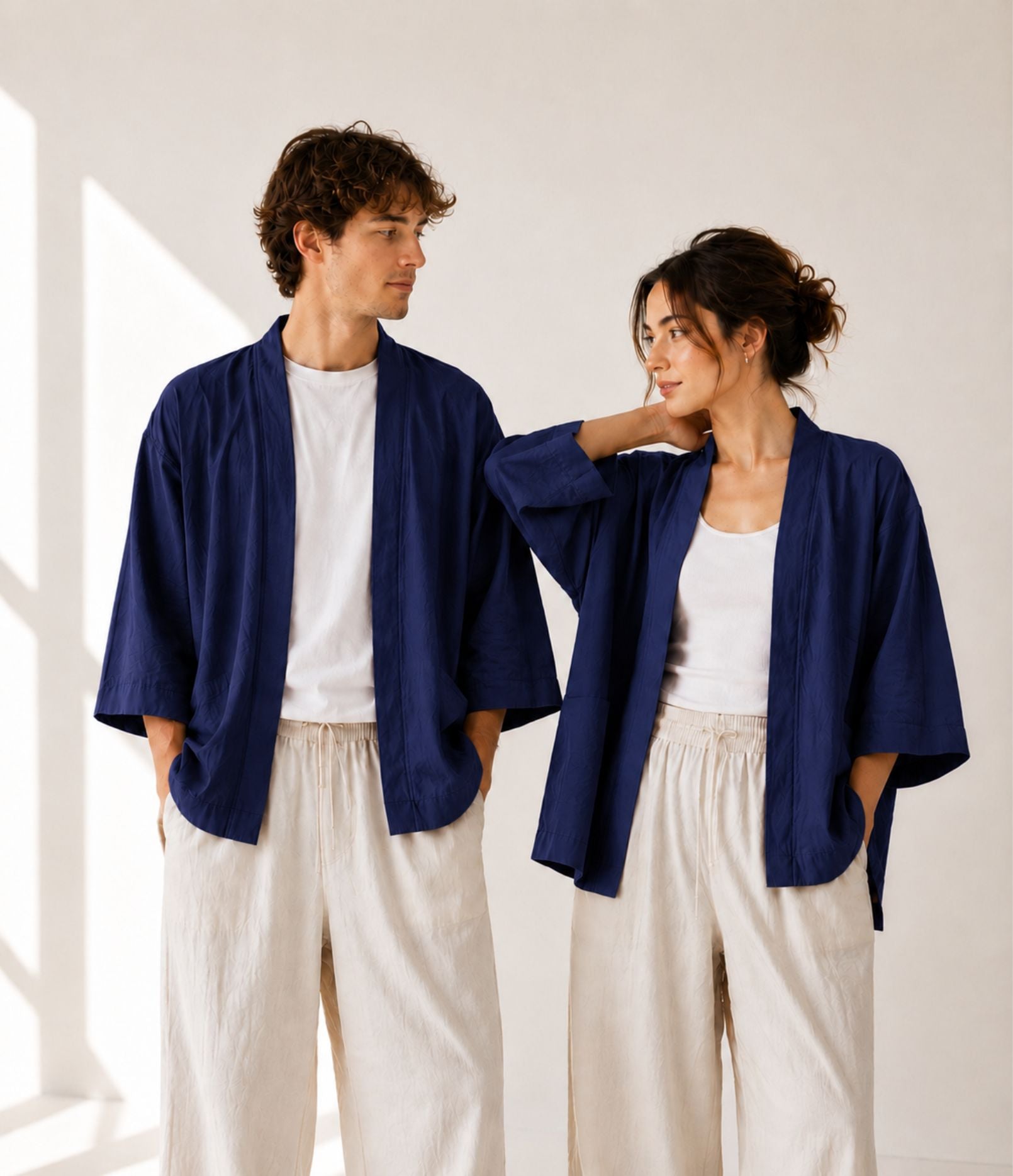 Man and woman wearing matching navy haori jackets over white tops