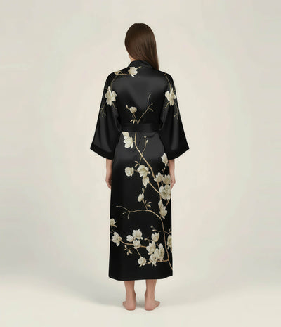 Back view of a black Japanese kimono robe for women with elegant floral print, long satin loungewear robe with waist belt.