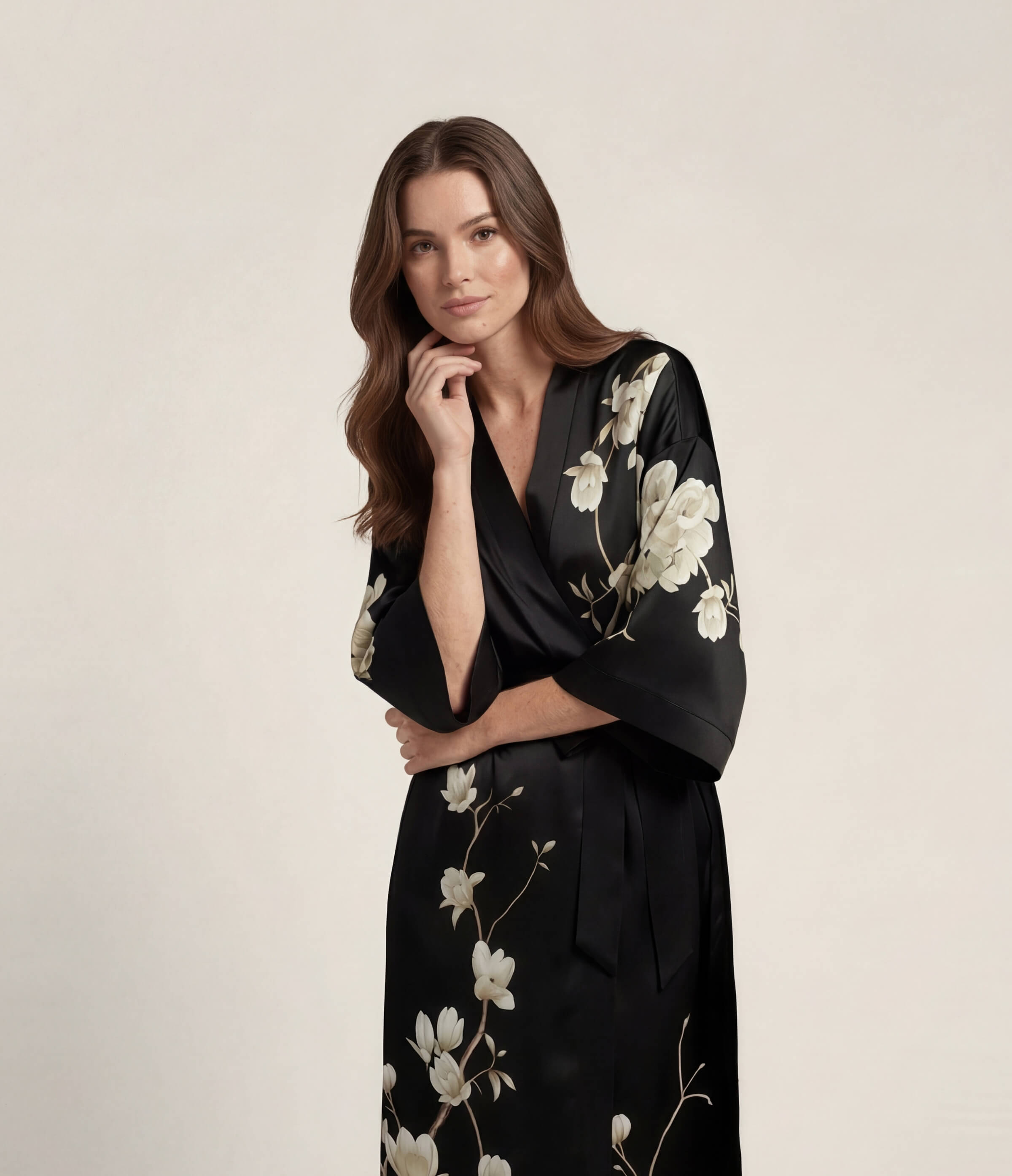 Front view of a black Japanese kimono robe for women with elegant floral print, long satin loungewear robe with waist belt.