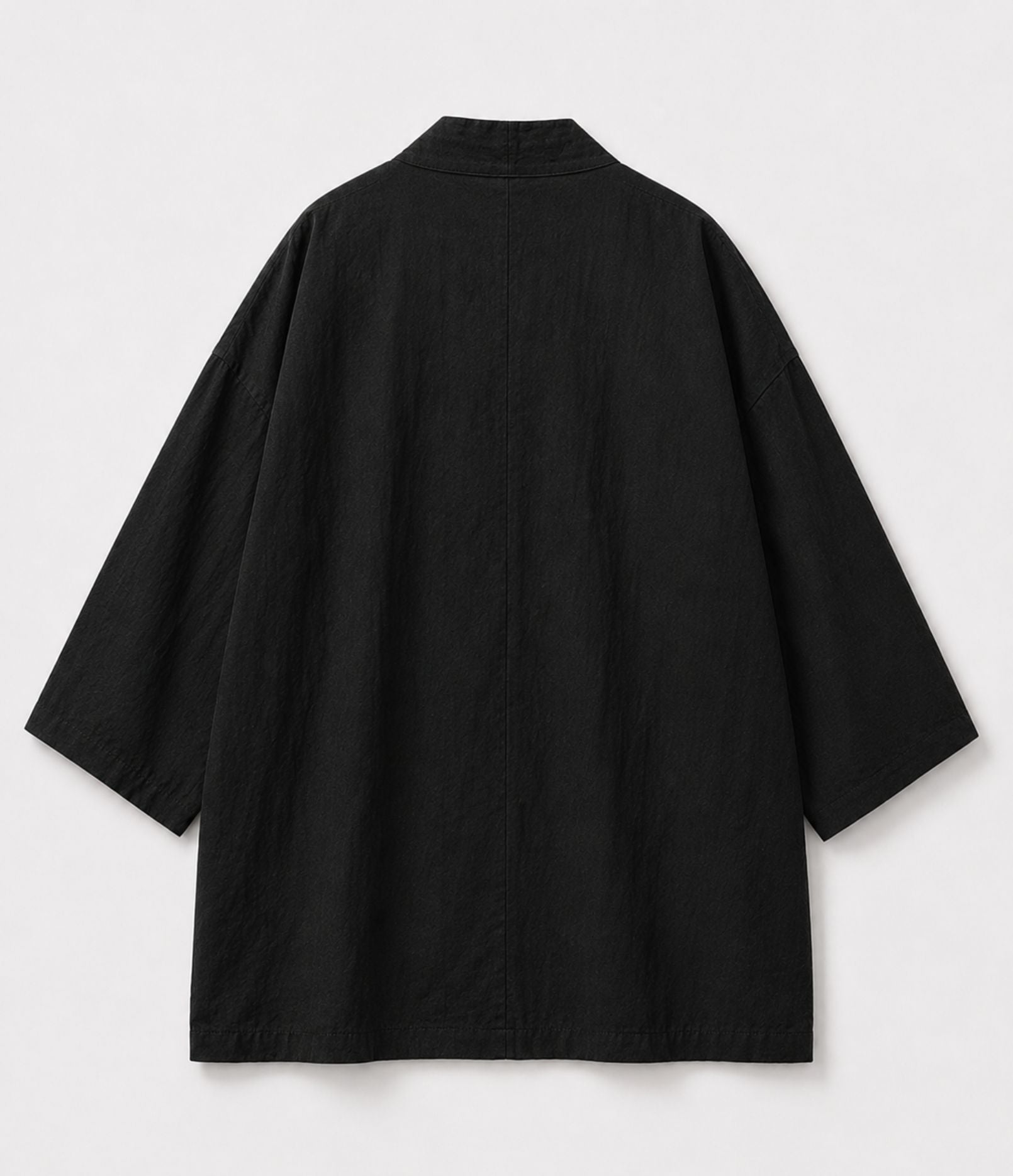 Back of a black kimono jacket showing centre seam and wide sleeves