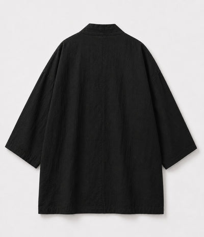 Back of a black kimono jacket showing centre seam and wide sleeves