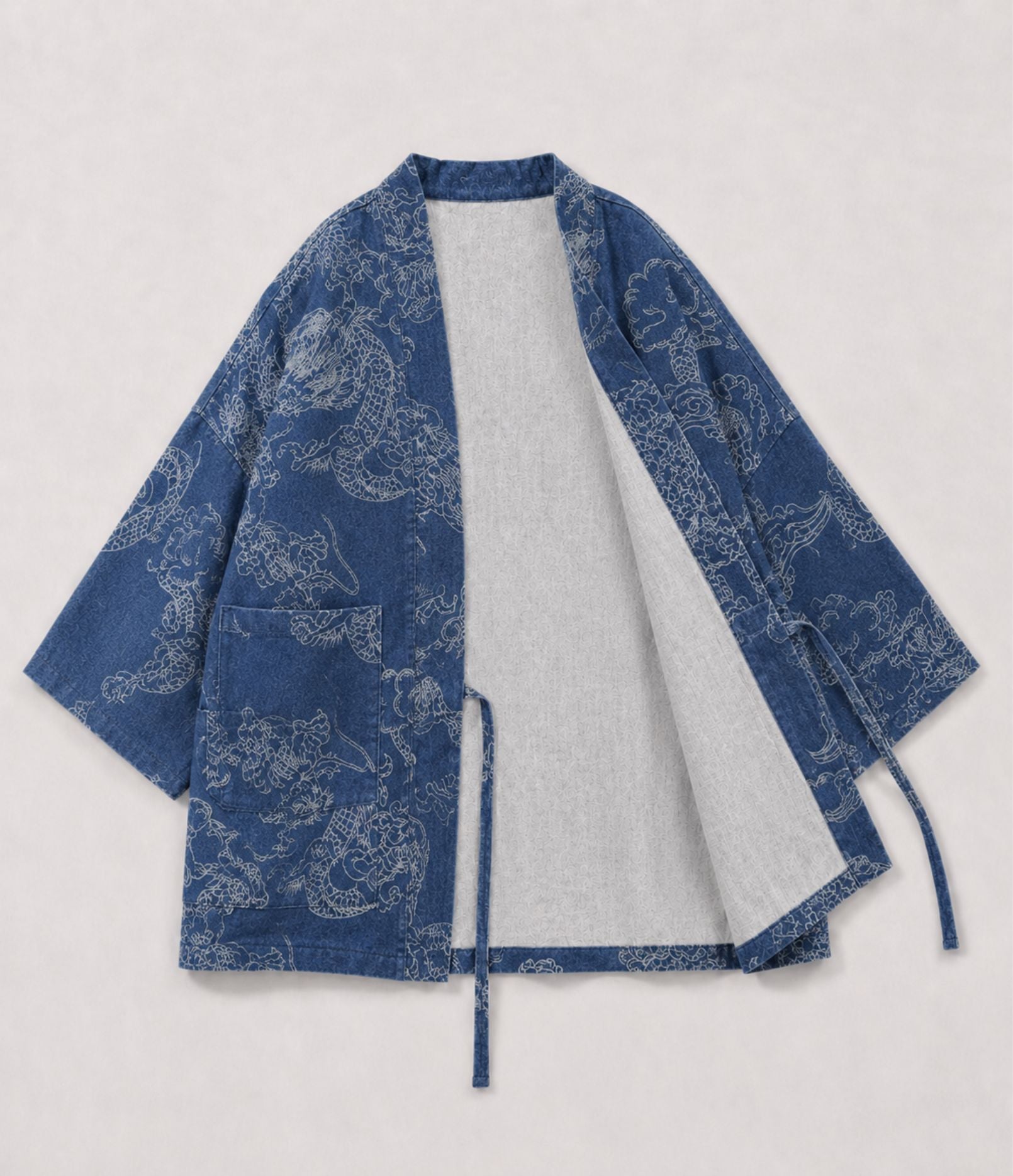 Indigo denim haori jacket with white dragon print, tie cords and patch pockets, front