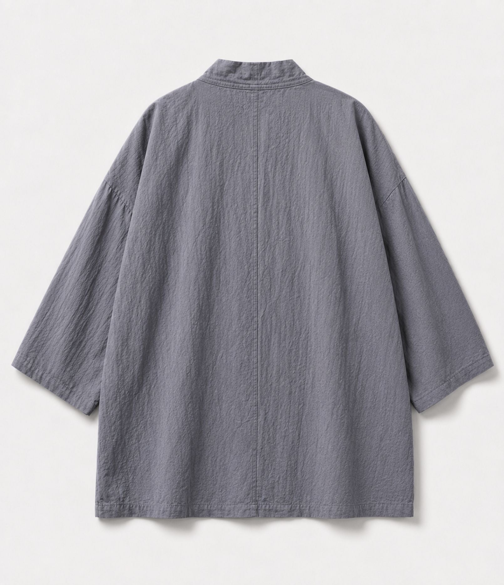 Back of a grey kimono jacket showing centre seam and wide sleeves
