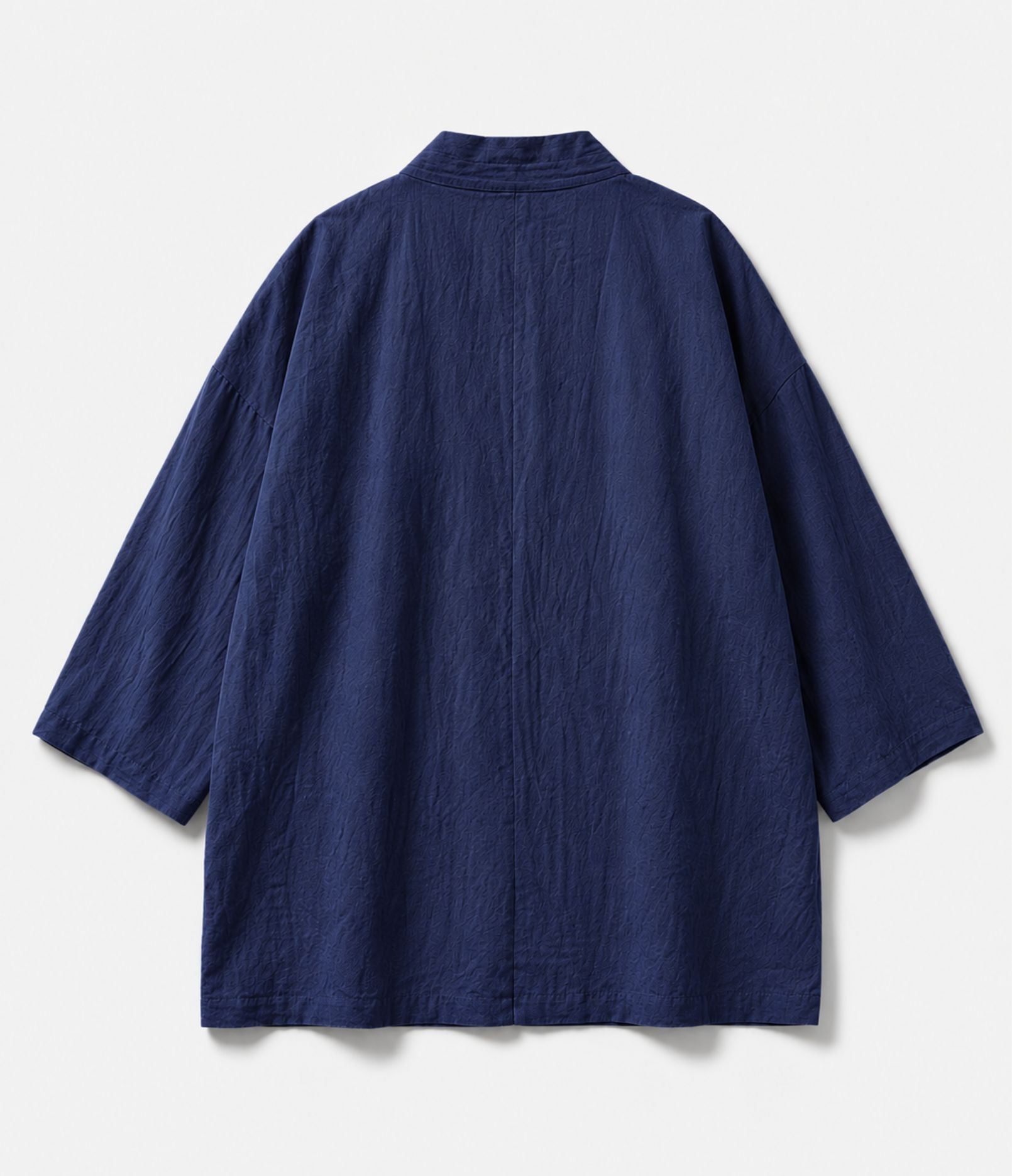 Back of an indigo kimono jacket showing centre seam and wide sleeves