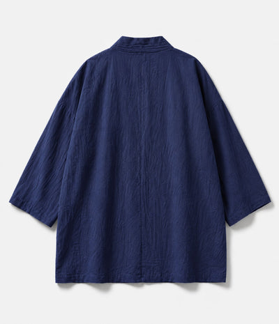 Back of an indigo kimono jacket showing centre seam and wide sleeves