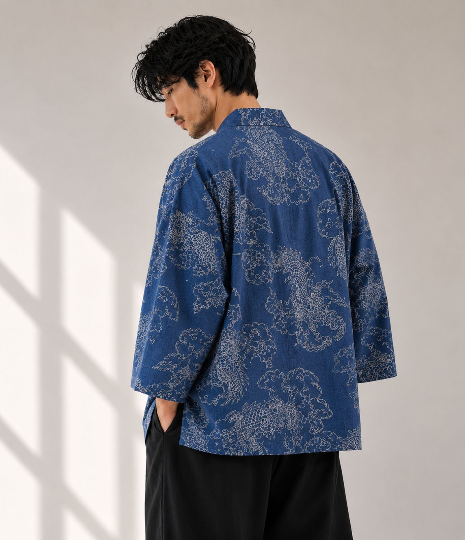 Back view of a man in an indigo denim dragon-print kimono cardigan