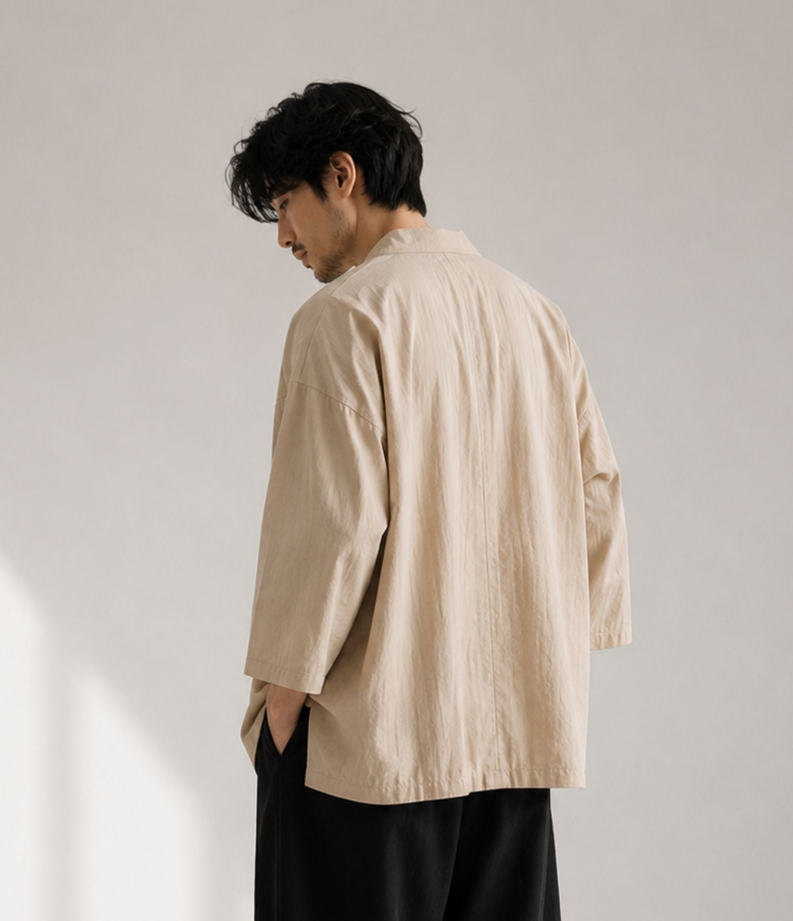 Back view of a man wearing a sand beige haori jacket