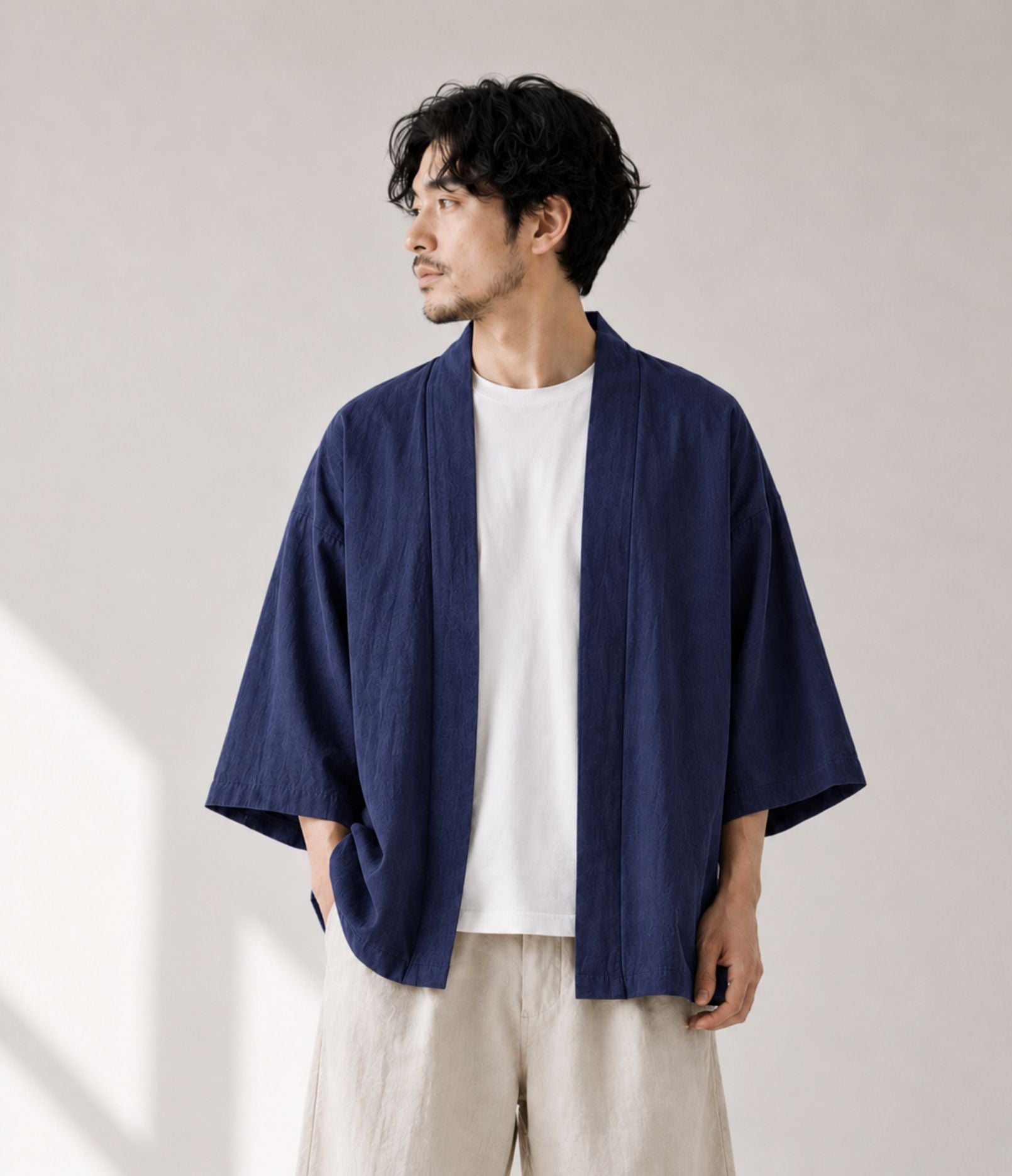Man wearing a navy noragi kimono cardigan over a white tee