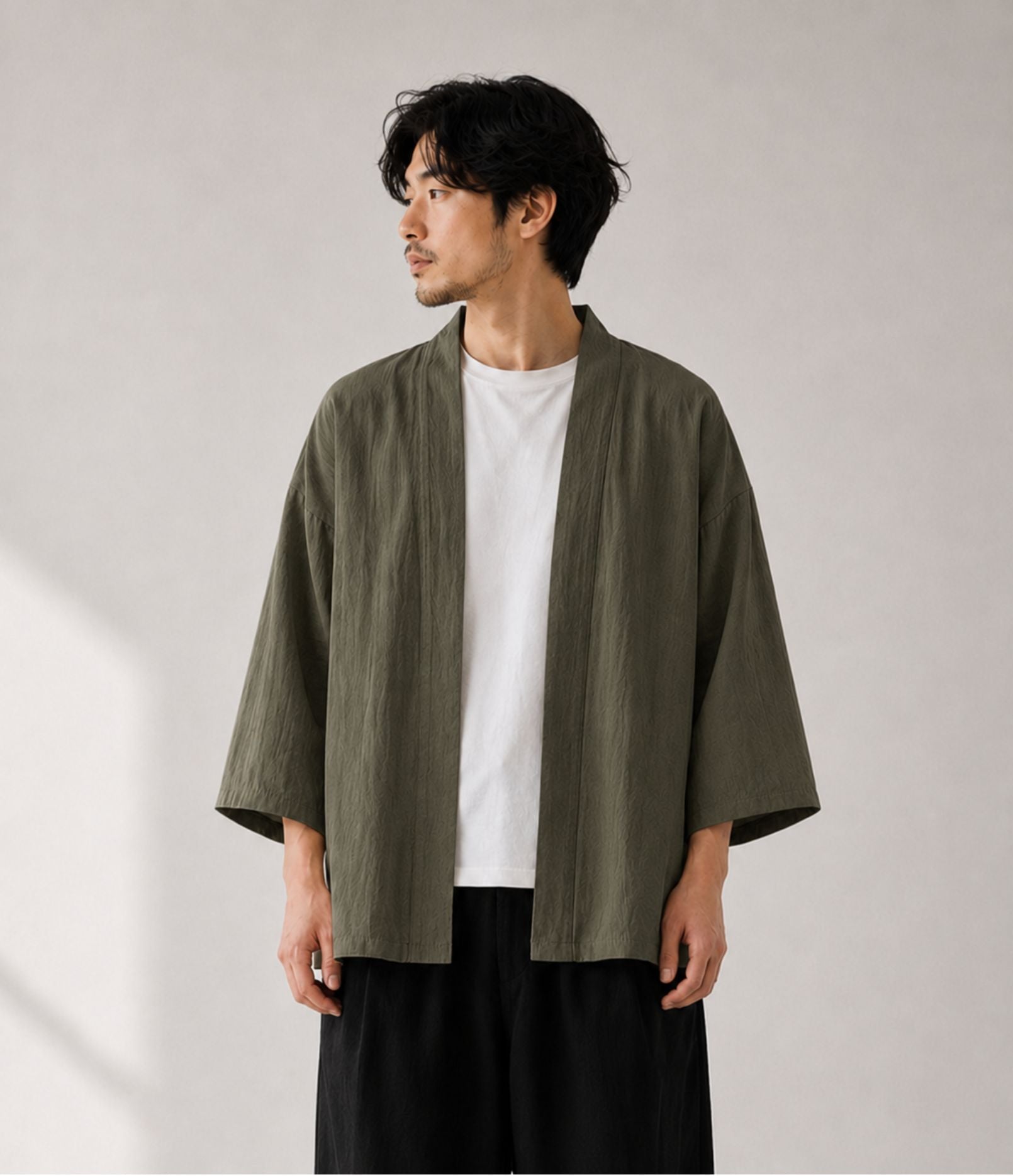 Man wearing an olive green noragi kimono cardigan over a white tee