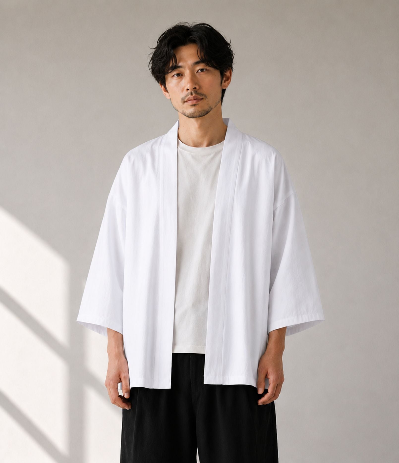 Man wearing a white noragi kimono cardigan over a beige tee