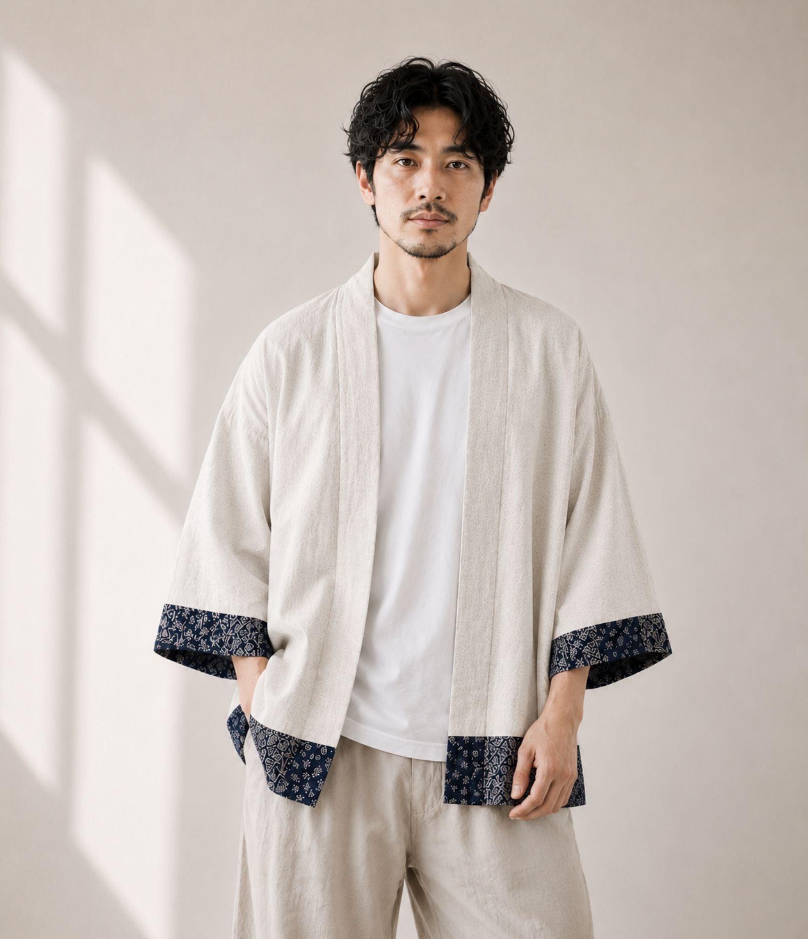 Man wearing a natural linen patchwork-trim haori jacket over a white tee