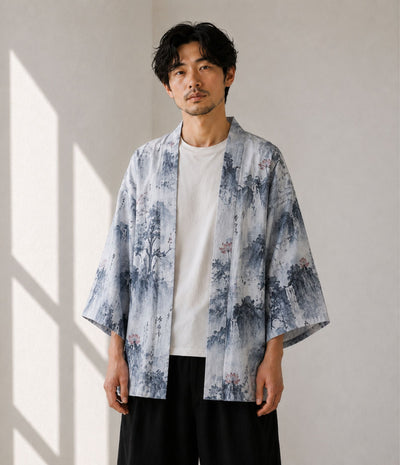 Man wearing a grey landscape-print kimono cardigan over a white tee