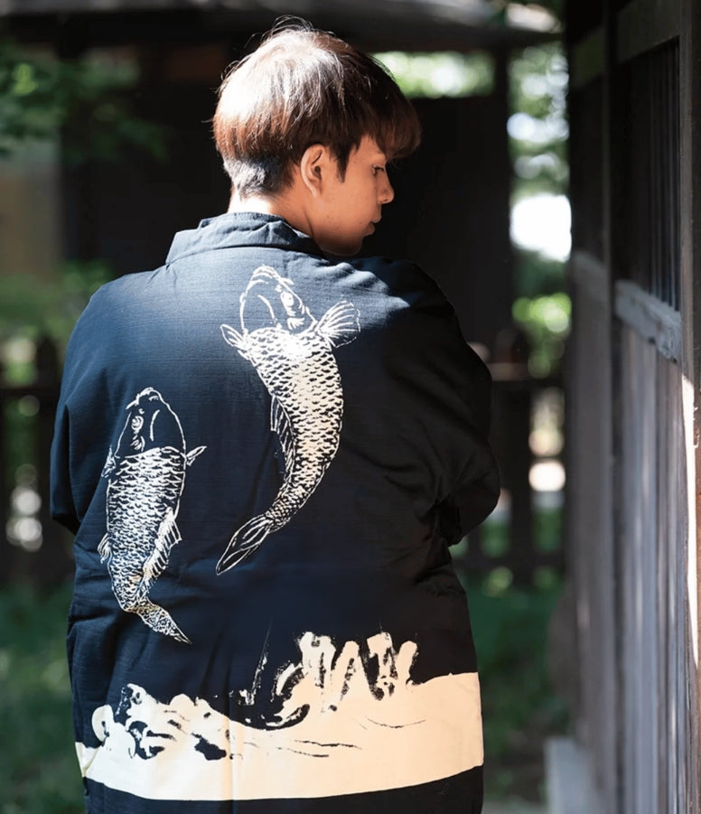 Man wearing navy hanten with koi fish, a Japanese coat brand