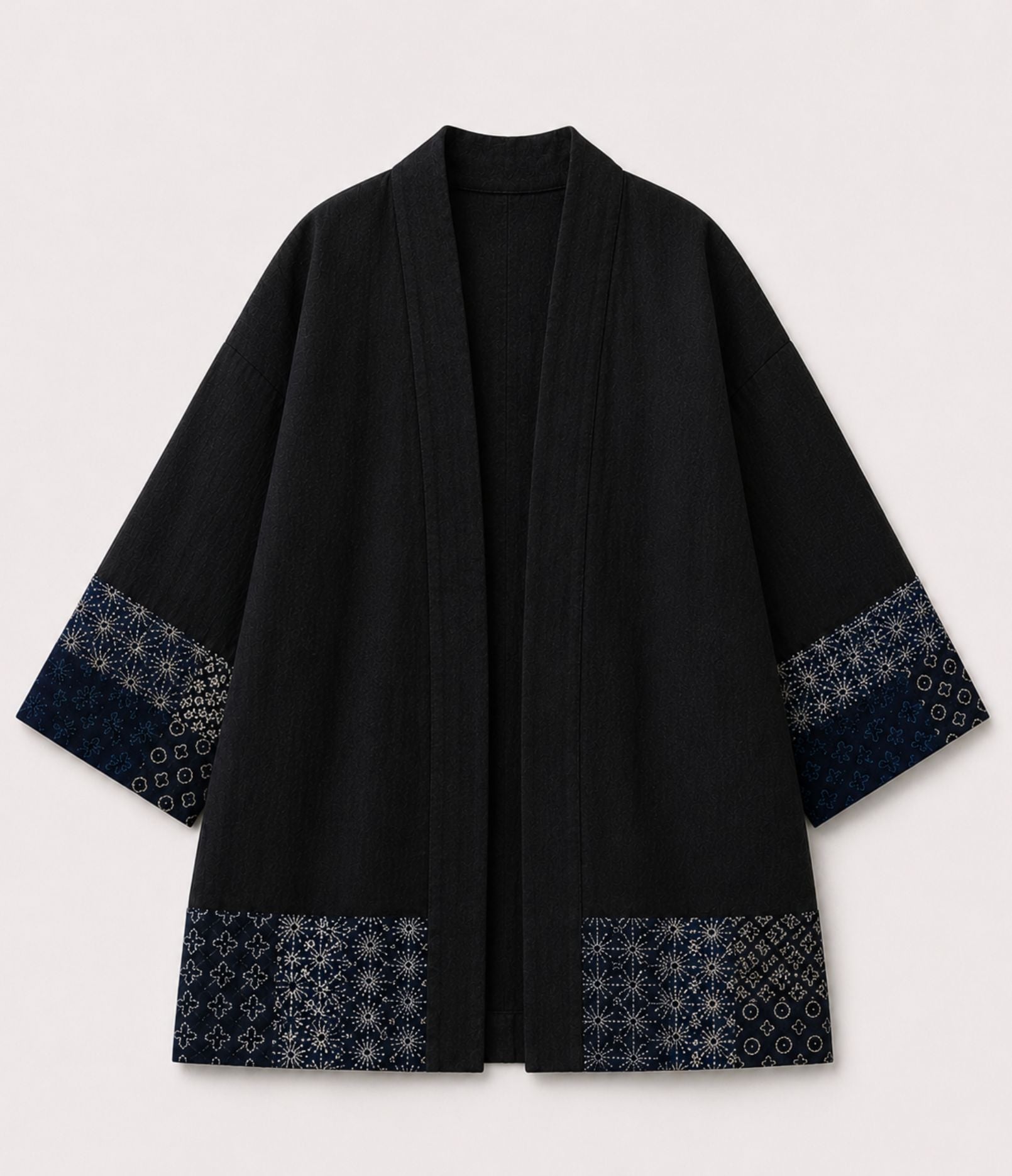 Black haori jacket with indigo patchwork print sleeve and hem trim, front