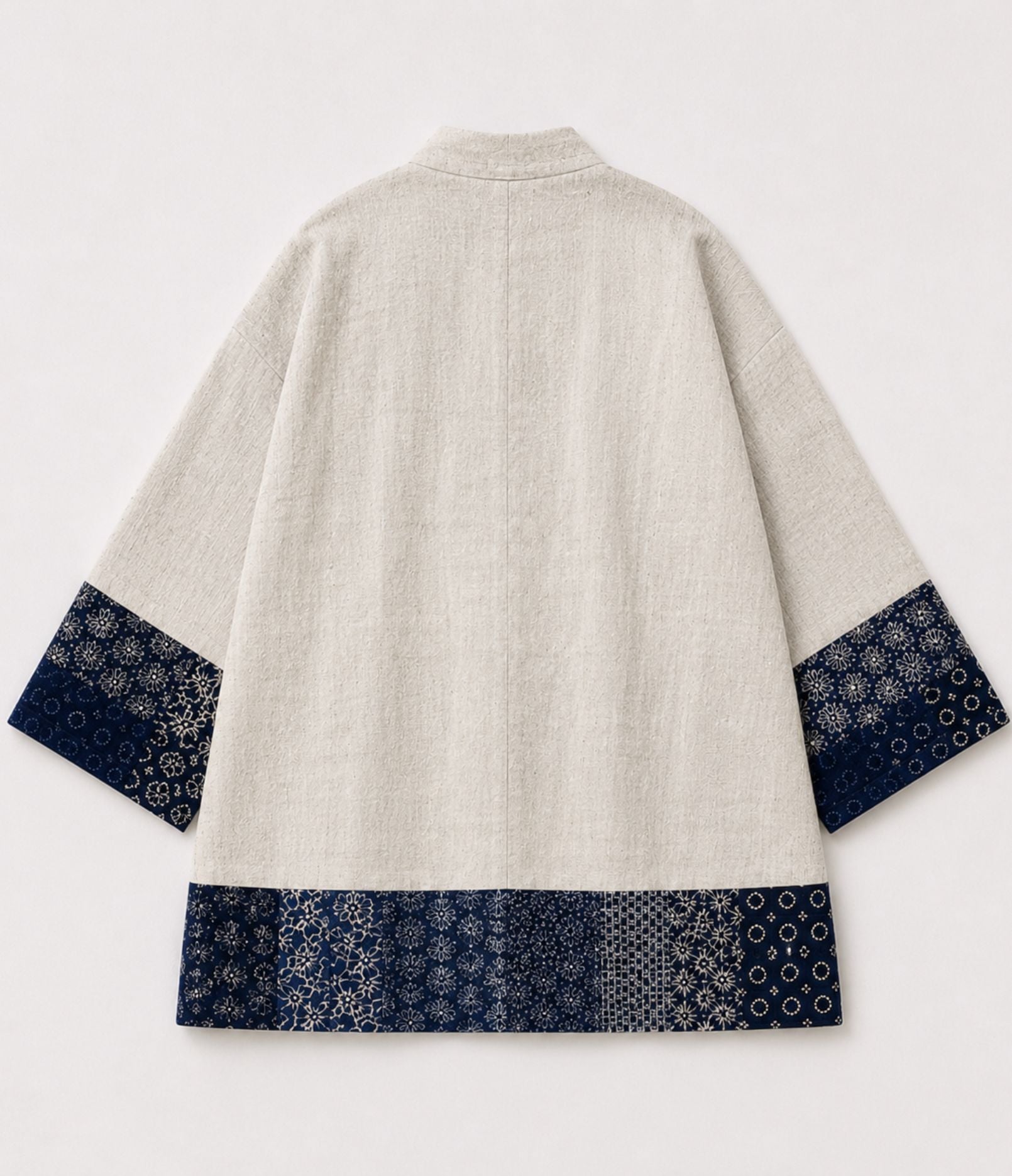 Back of a natural linen kimono jacket with indigo sashiko-style patchwork trim