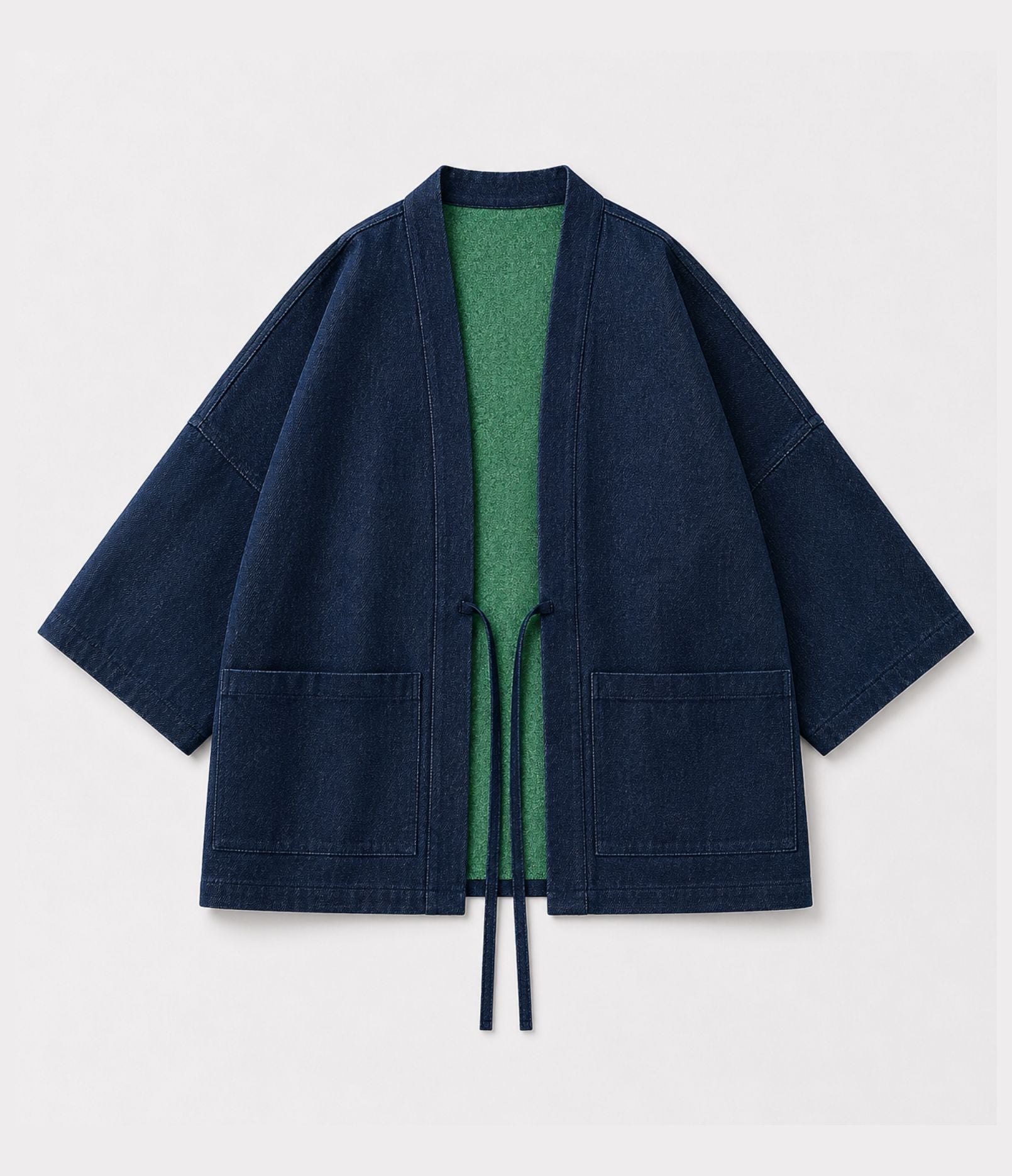 Navy denim side of a reversible haori jacket showing green lining and patch pockets