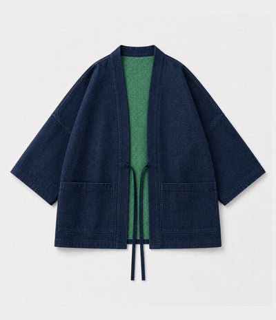 Navy denim side of a reversible haori jacket showing green lining and patch pockets