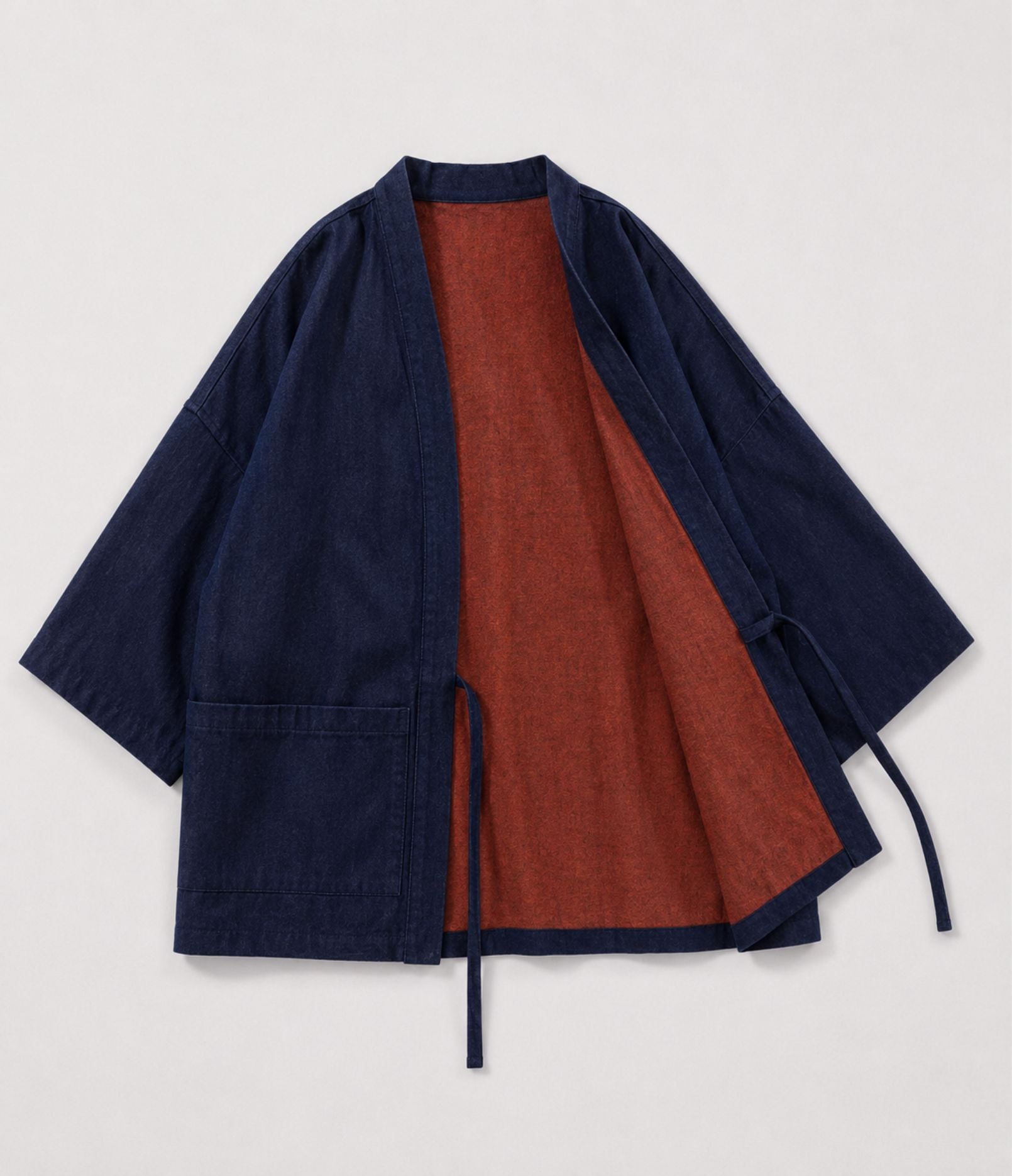 Navy denim side of a reversible haori jacket showing rust lining and patch pockets