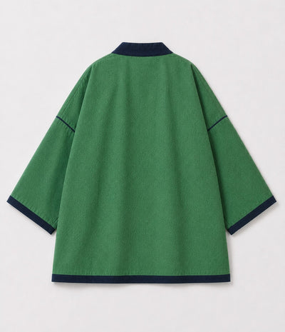 Back of a green reversible kimono jacket with contrast navy trim