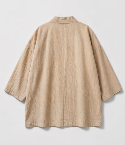 Back of a sand beige haori jacket showing collar and wide sleeves
