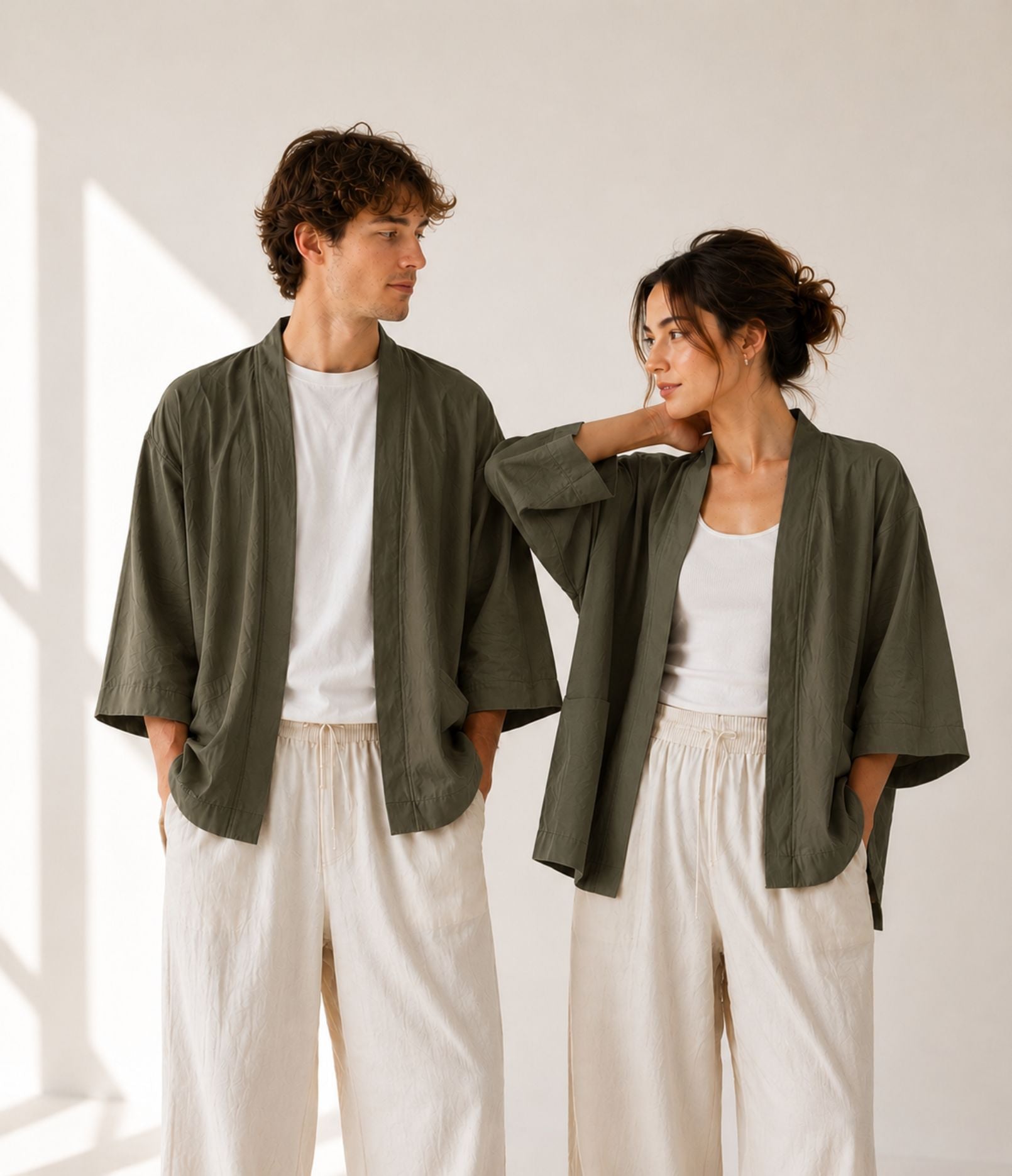 Man and woman wearing matching olive green unisex haori jackets over white tops