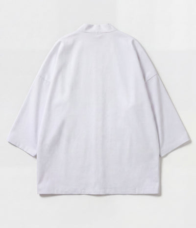 Back of a white kimono jacket showing centre seam and wide sleeves