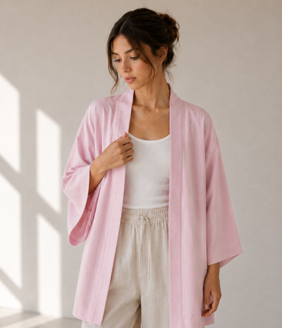 Woman wearing a lightweight pink haori jacket over a white tank top