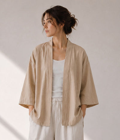 Woman wearing a sand beige haori jacket over a white tank top
