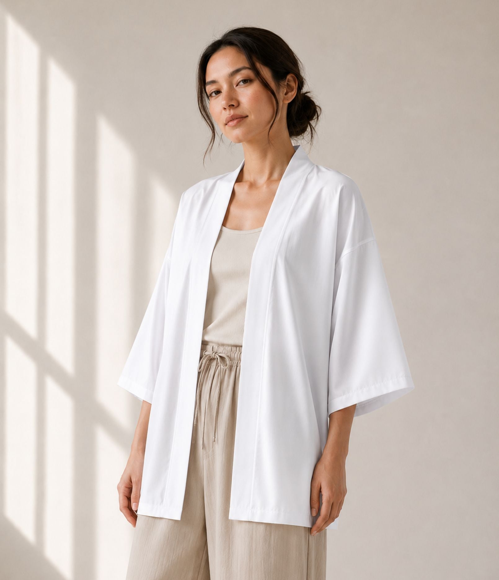Woman wearing a lightweight white haori jacket over a beige tank top
