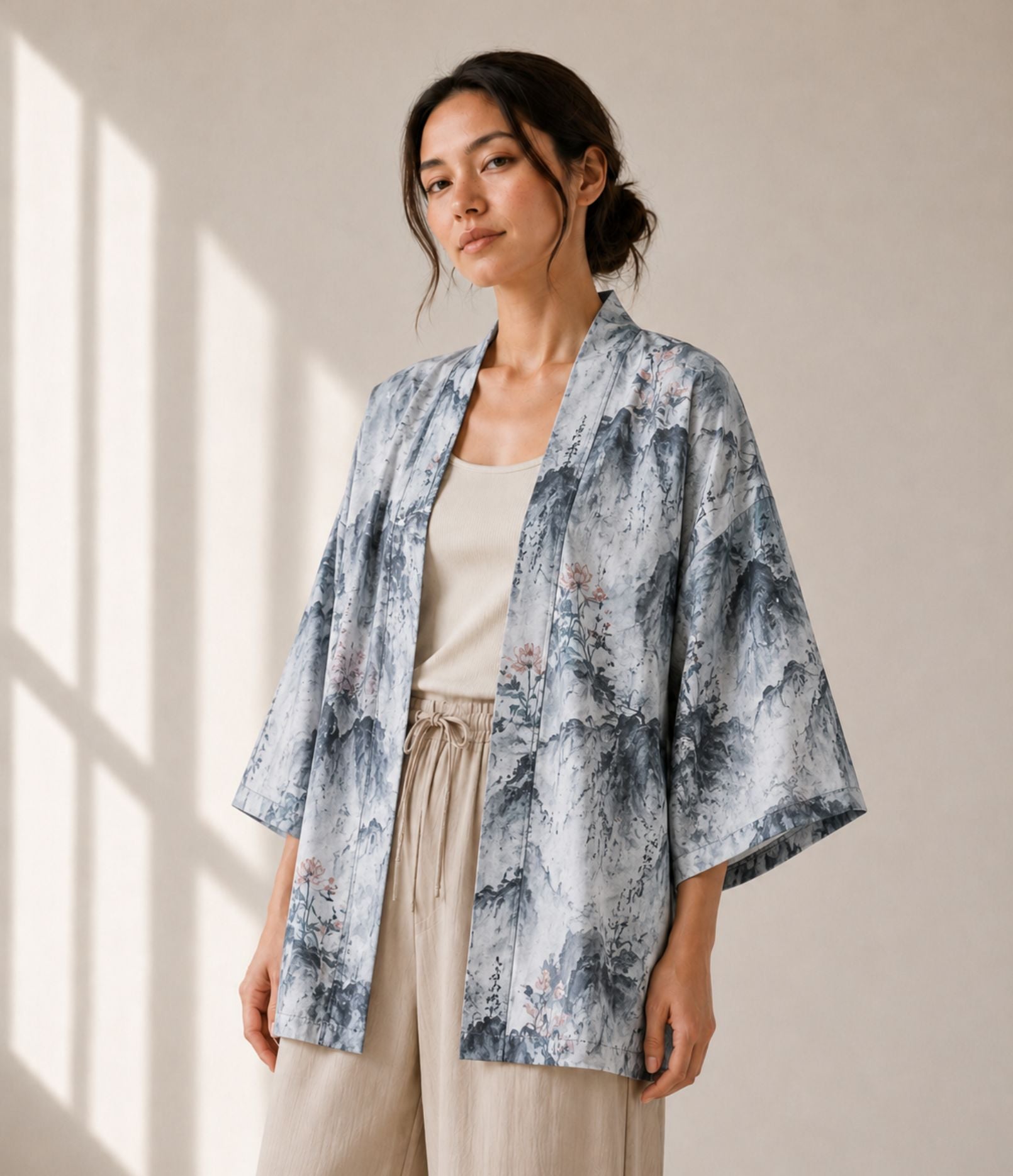 Woman wearing a grey lotus-print haori jacket over a beige tank top