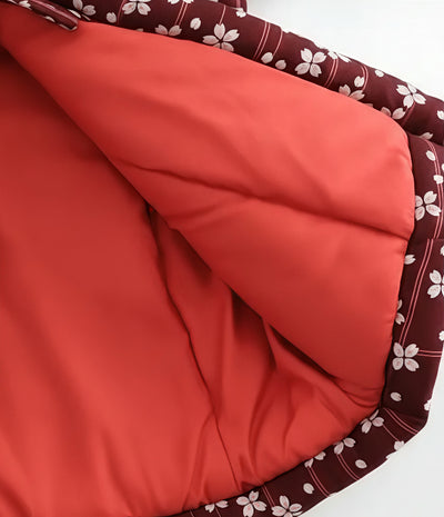 Close-up of inner lining detail of women’s red Japanese hanten jacket with sakura floral pattern