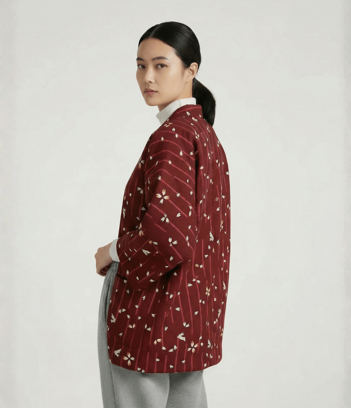 Side view of women’s red Japanese hanten jacket with sakura floral pattern